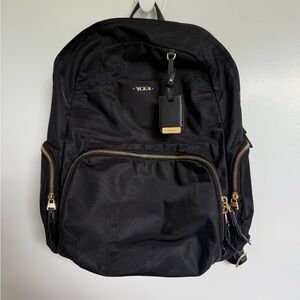 TUMI Black Backpack with Gold Accents